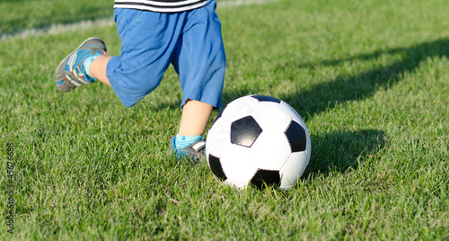 Child kicking a soccer ball
