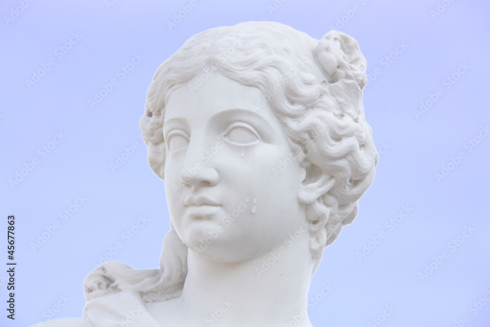 beatiful woman white marble statue face with tears on a cheek