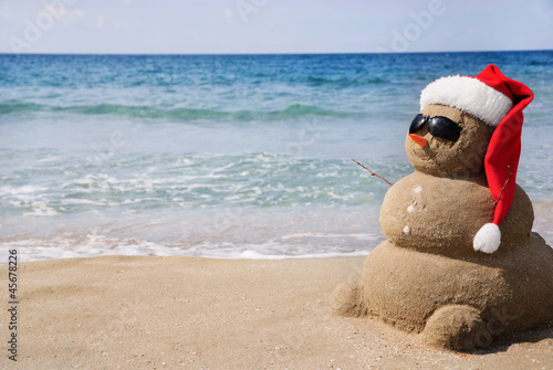 Snowman made out of sand. Holiday concept can be used for New Ye