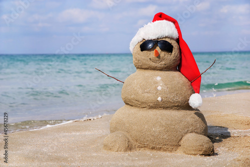 Snowman made out of sand. Holiday concept can be used for New Ye