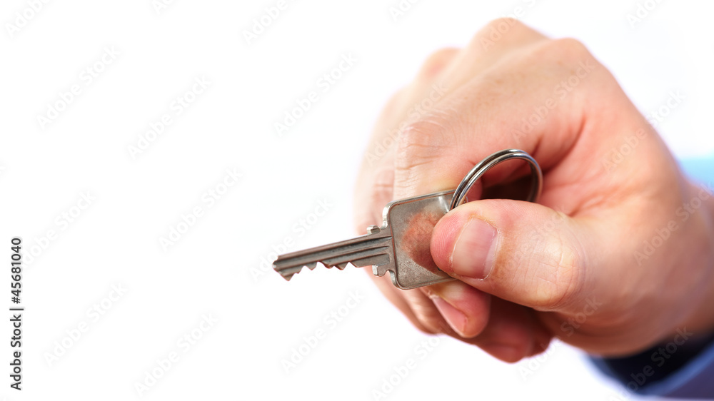 Hand with a house key. Hand with a house key.
