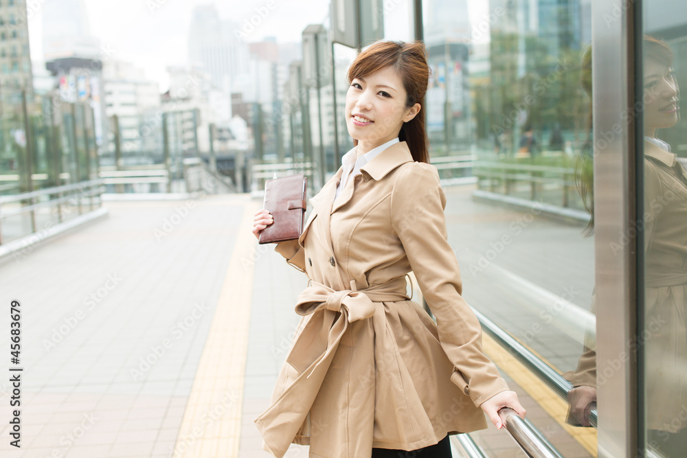 Fototapeta premium Beautiful business woman walking outside her office