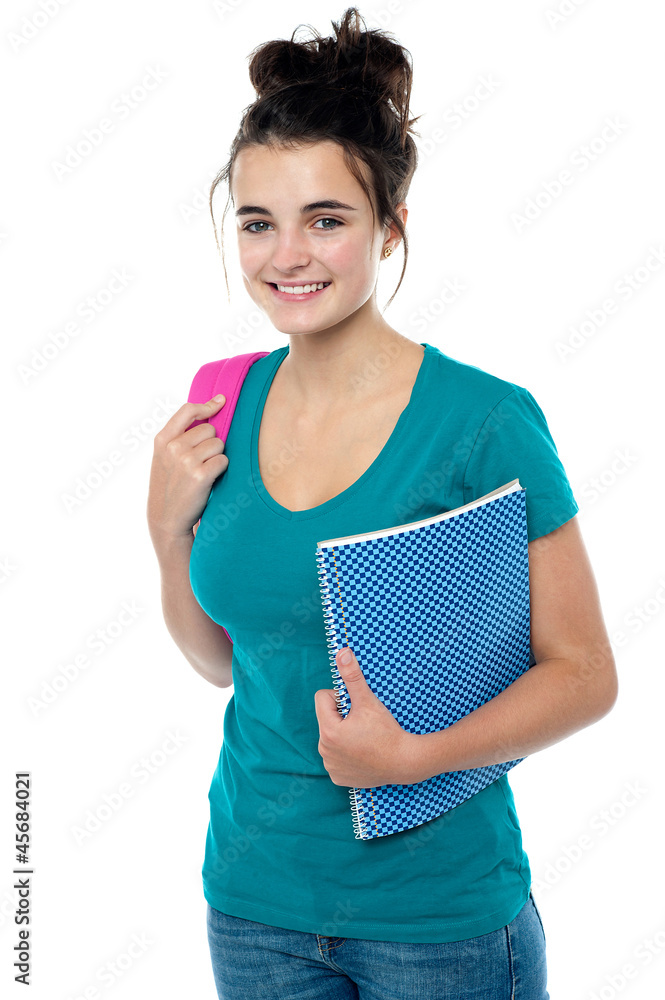 College student carrying backpack and spiral notebook College student carrying backpack and spiral notebook