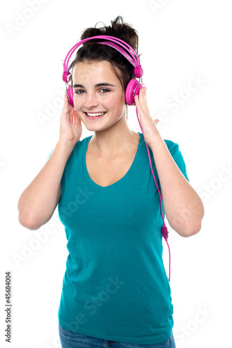 Cheerful pretty girl listening to music © stockyimages
