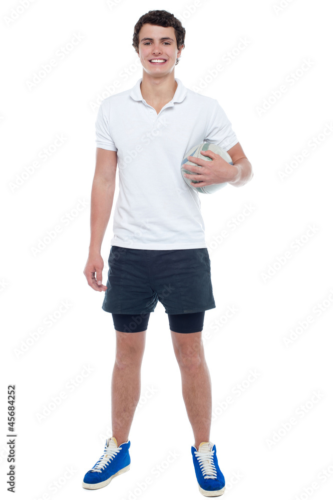 Energetic football player holding ball tightly Energetic football player holding ball tightly