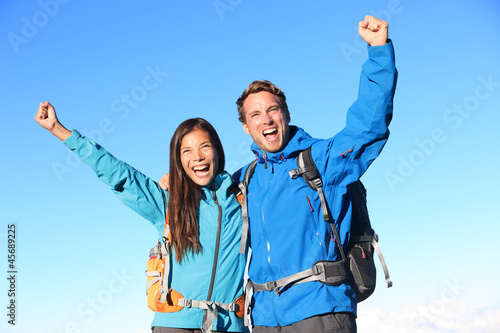 Happy hiking couple cheering