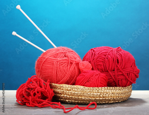 Red knittings yarns in basketon photo