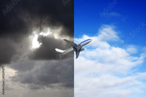 Plane flying out of stormy sky into blue sky