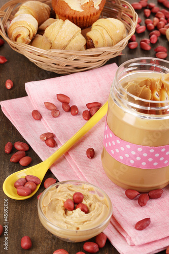 Delicious peanut butter in jar with baking