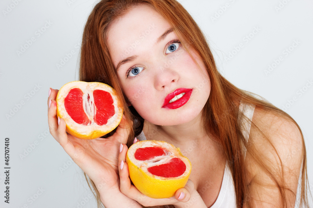 Portrait of young beautiful woman with red grapefruit Portrait of young beautiful woman with red grapefruit