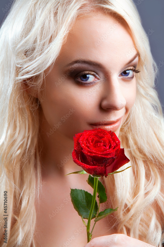 girl with red rose in her blond hair girl with red rose in her blond hair