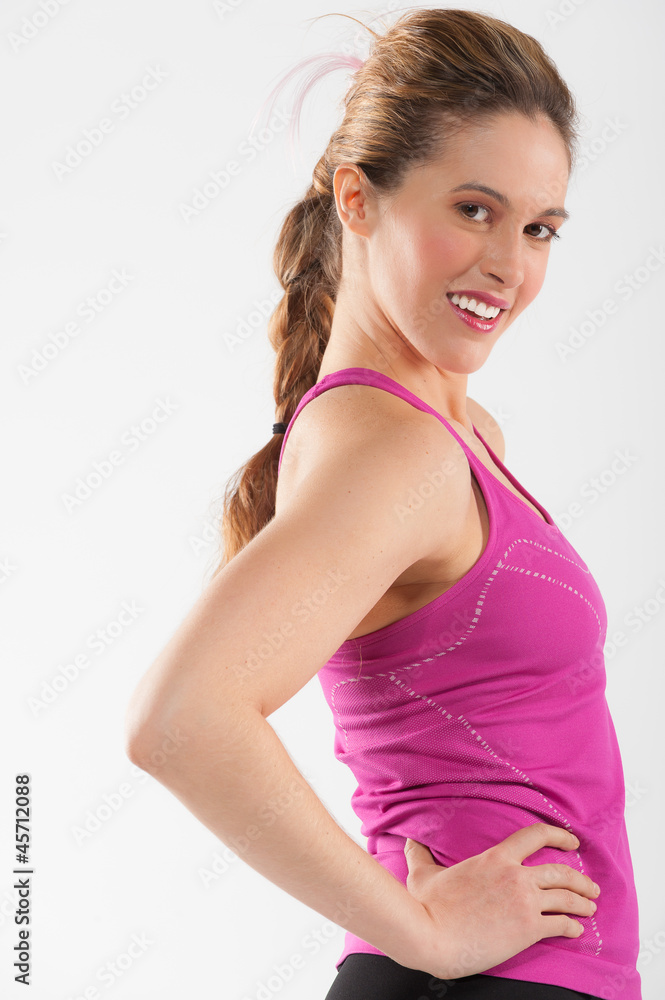 Happy young woman in pink and black fitness outfit. Happy young woman in pink and black fitness outfit.