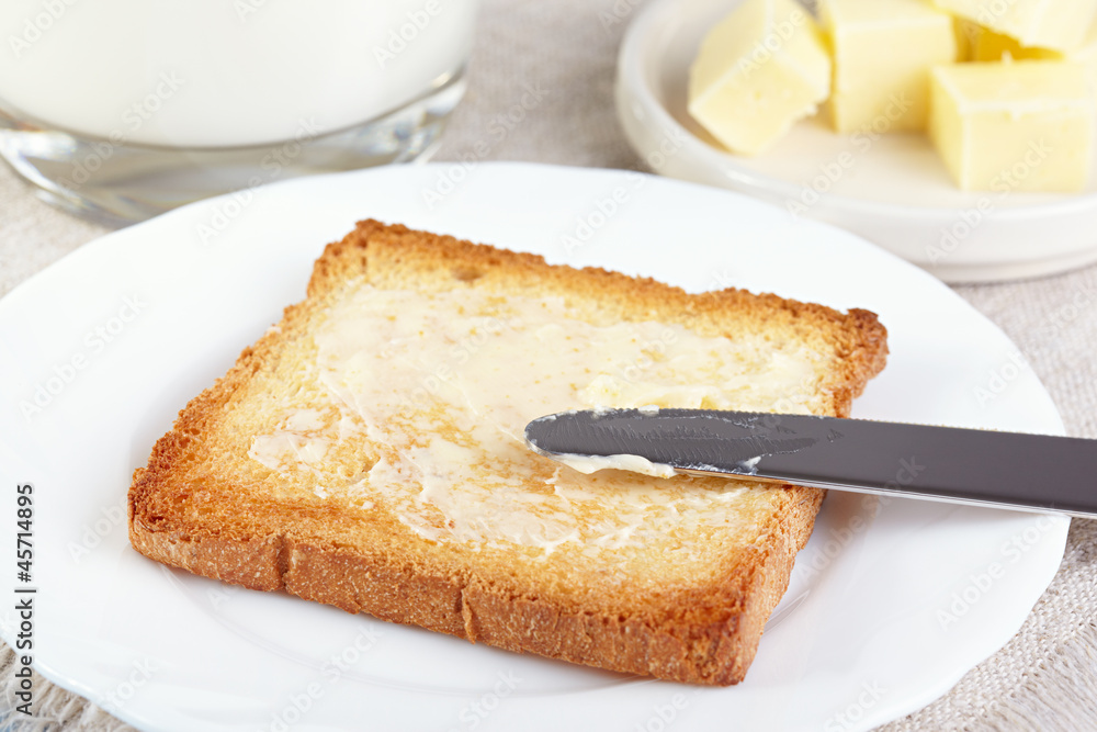 Breakfast. Glass with milk and toasts with butter Breakfast. Glass with milk and toasts with butter