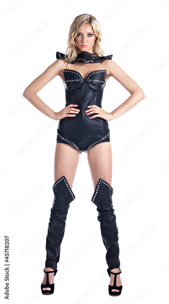 Sexy blond woman in leather corset stand isolated