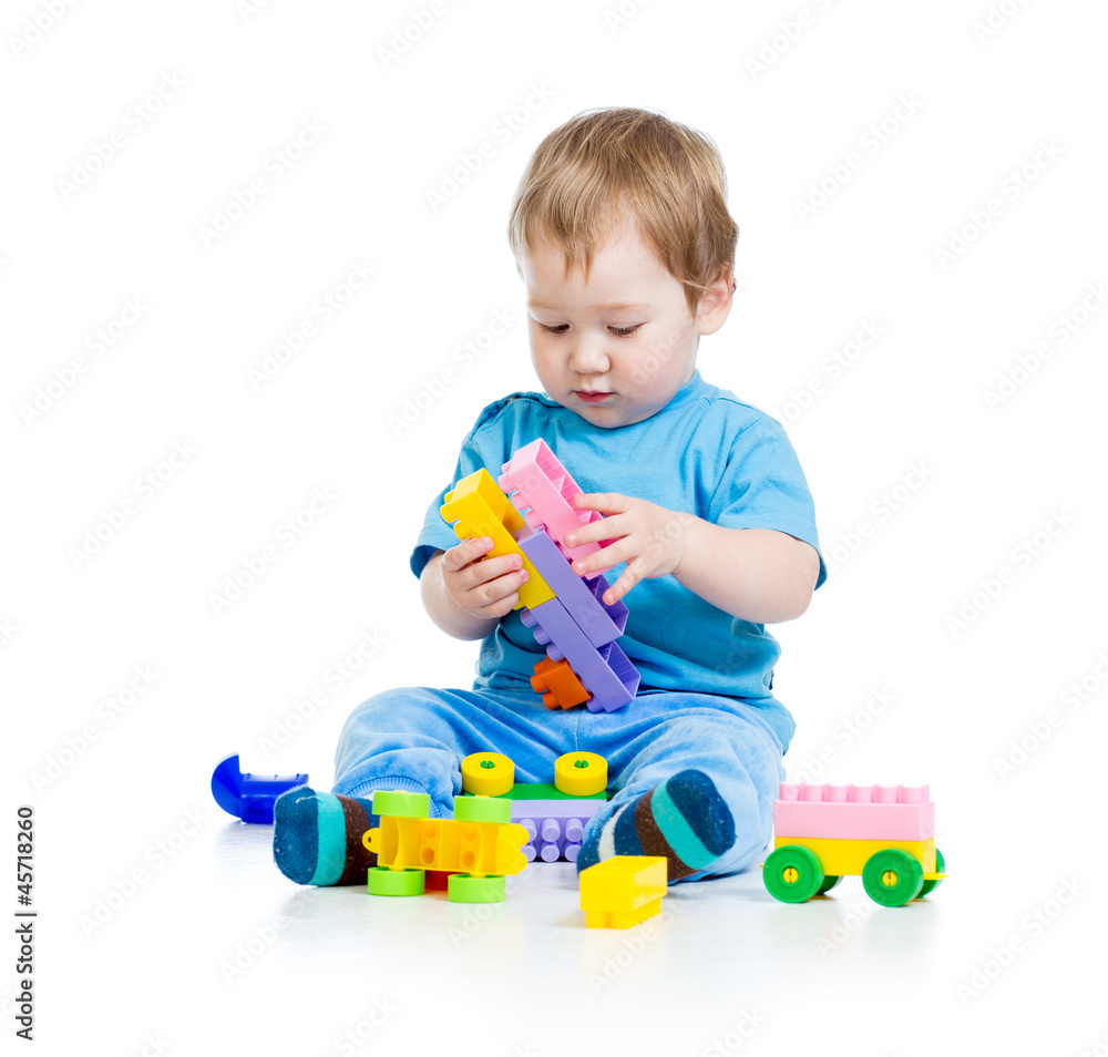 little cheerful child with construction set over white backgroun little cheerful child with construction set over white backgroun