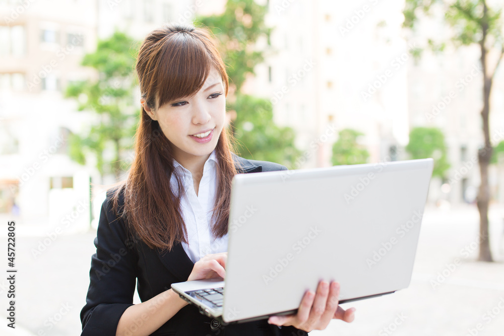 Beautiful business woman using a laptop computer Beautiful business woman using a laptop computer