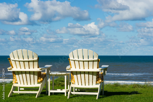two beach chairs on an empty meadow