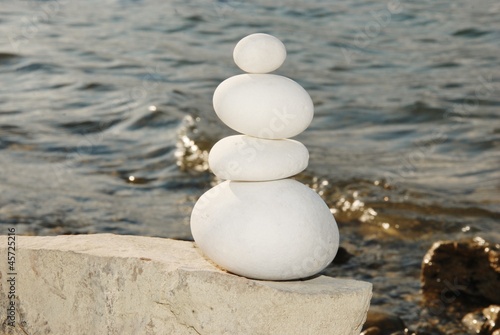 round stones stacked background water