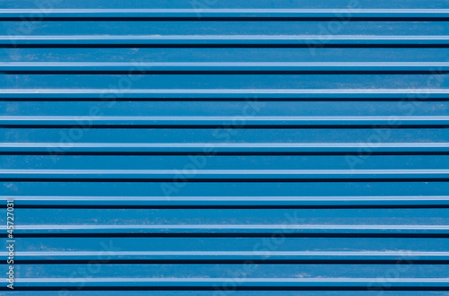 Horizontal ridged blue painted metal wall texture