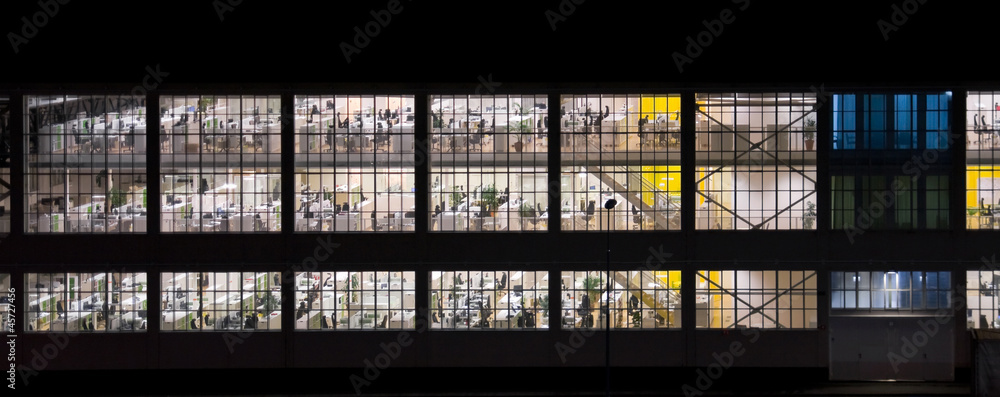 Wall with windows of an empty office building at night Wall with windows of an empty office building at night