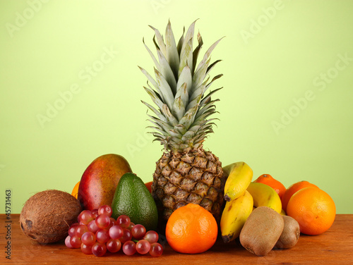 still life of fruit on a table on a green background