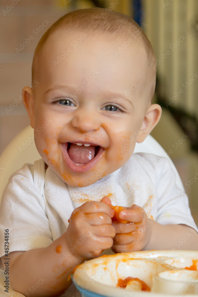 curious baby boy eating an apricot curious baby boy eating an apricot
