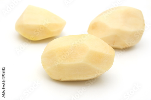 peeled potatoes on a white background