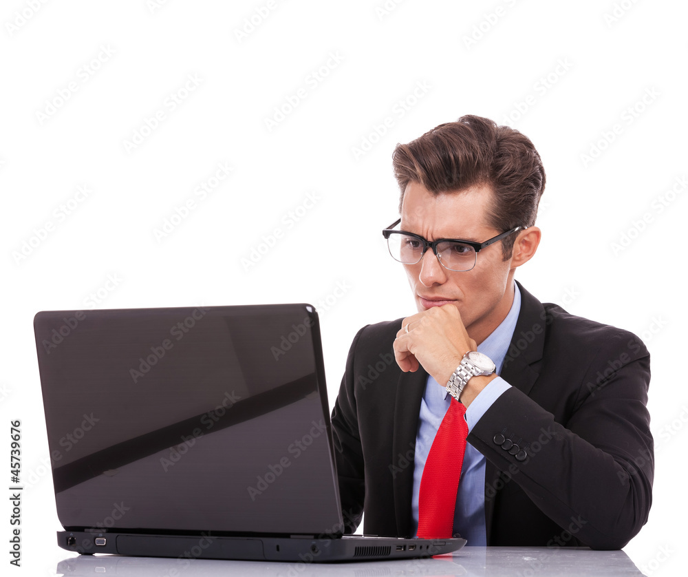 young business man looking serious at laptop young business man looking serious at laptop