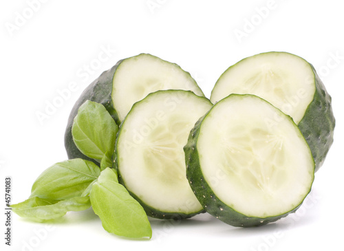 Sliced cucumber vegetable and basil leaves still life
