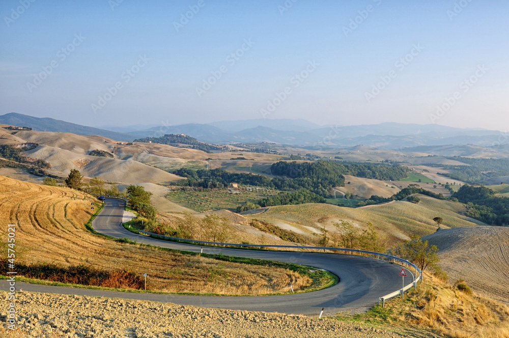 Winding road in autumn Tuscany, Italy