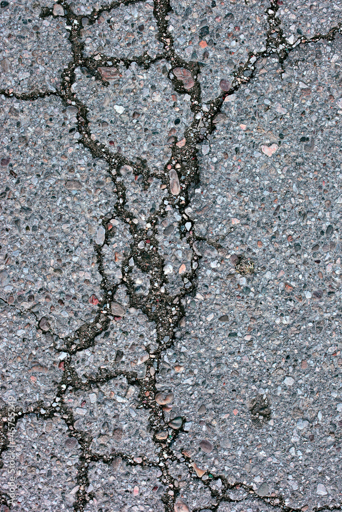 Cracked Road with Pebbles Background and Texture Cracked Road with Pebbles Background and Texture