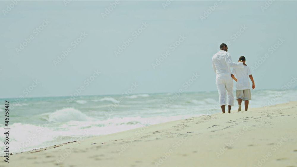 Ethnic happy father have fun with son on beach Ethnic happy father have fun with son on beach