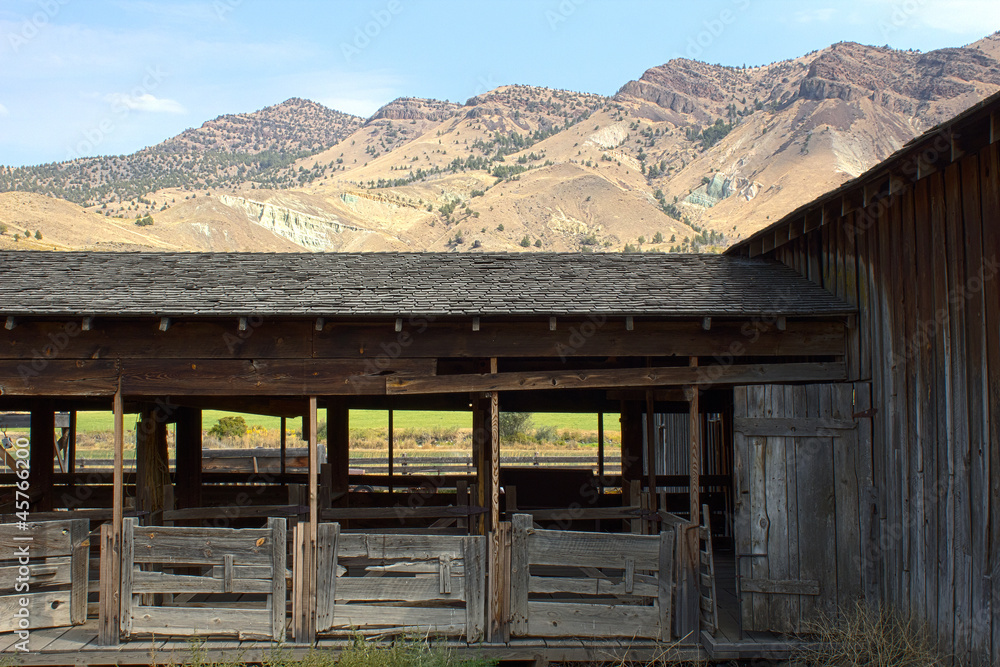 Vintage wooden livestock holding pens with mountain background