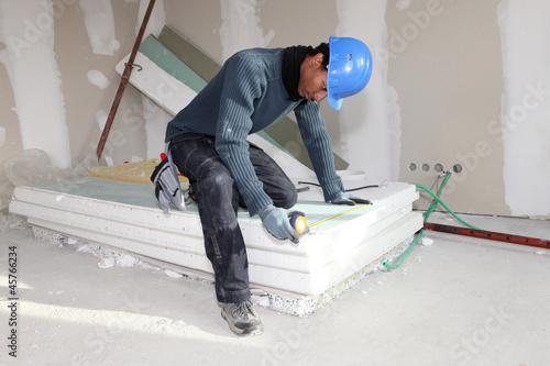 Worker using a measuring tape