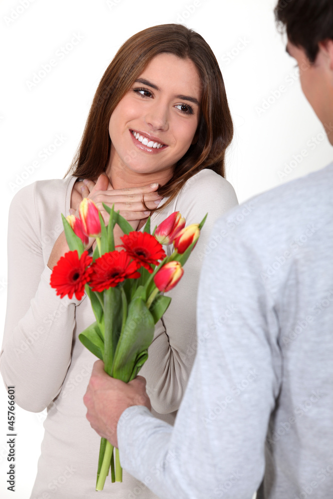 young romantic guy offering his belle flowers young romantic guy offering his belle flowers