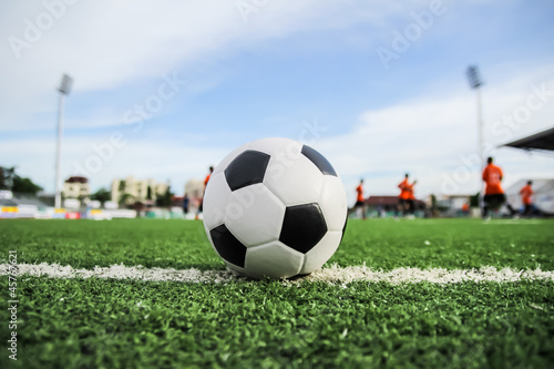 soccer ball on green grass © tungphoto