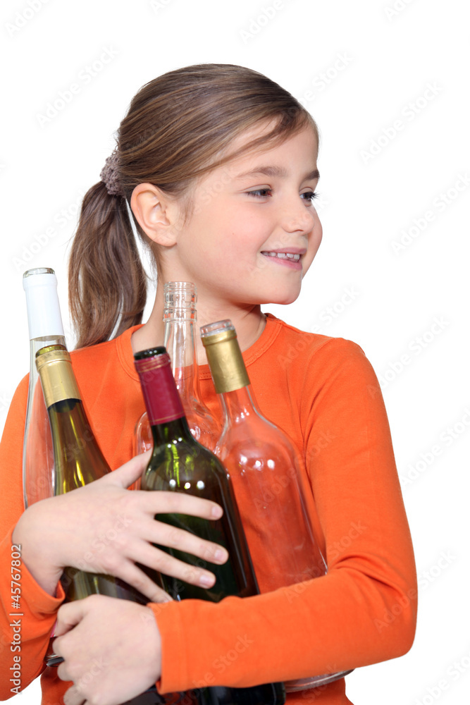 Little girl holding empty glass bottles Little girl holding empty glass bottles