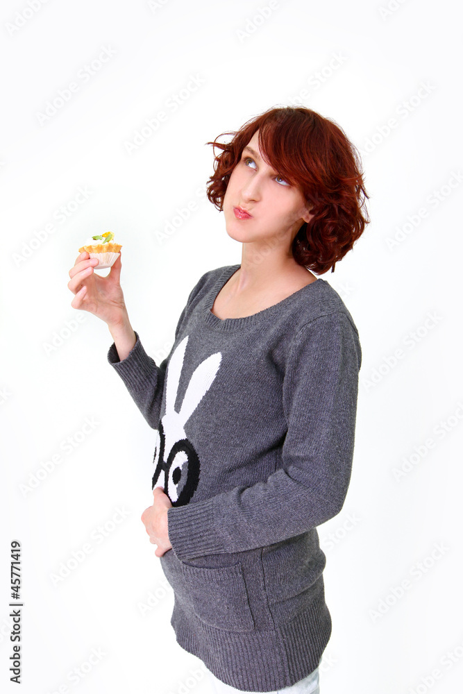 Girl eating cake and holding his stomach isolated on white backg Girl eating cake and holding his stomach isolated on white backg