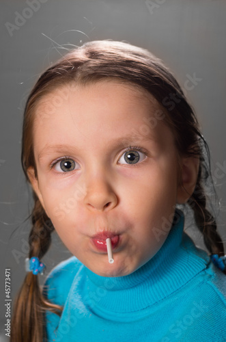Little girl with lollipop .