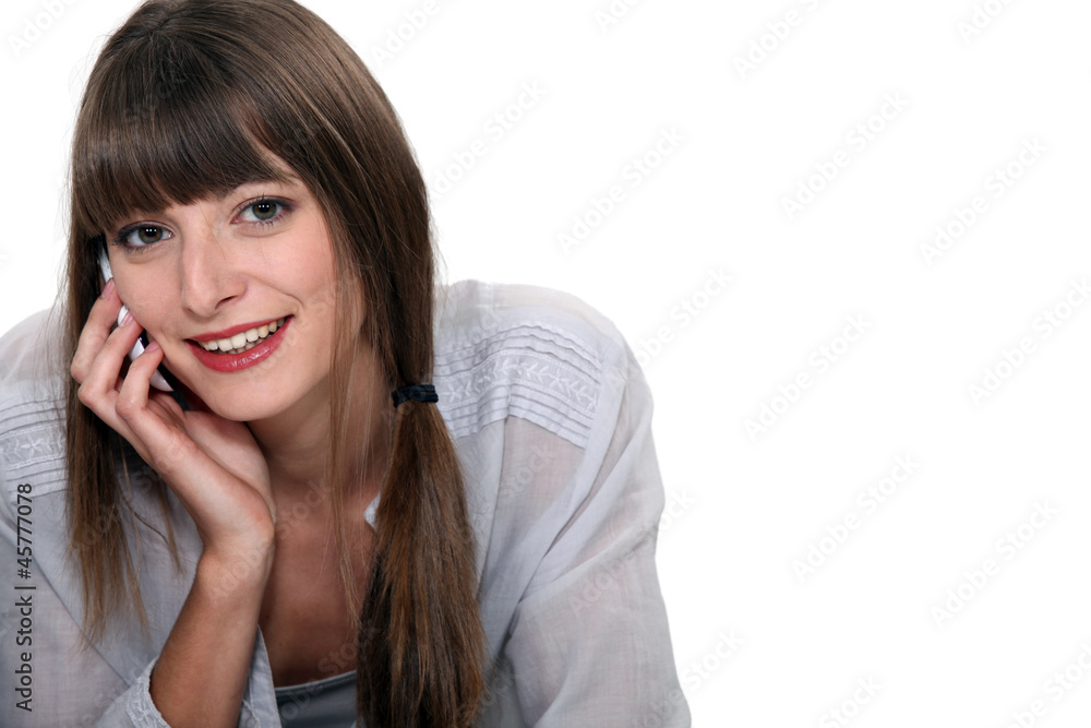 Young woman talking on her mobile phone Young woman talking on her mobile phone