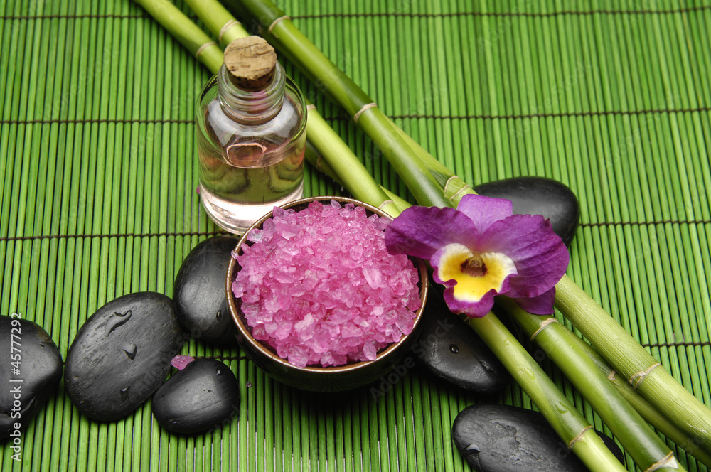 grove and salt in bowl with orchid with massage oil on mat grove and salt in bowl with orchid with massage oil on mat