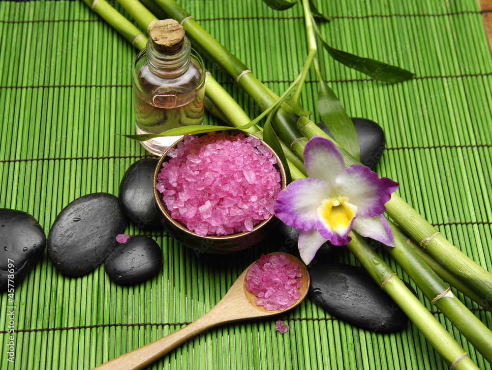 Bamboo grove and salt in bowl with orchid with massage oil Bamboo grove and salt in bowl with orchid with massage oil