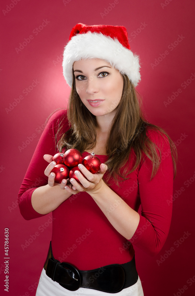 Woman with Santa Hat holding christmas balls Woman with Santa Hat holding christmas balls