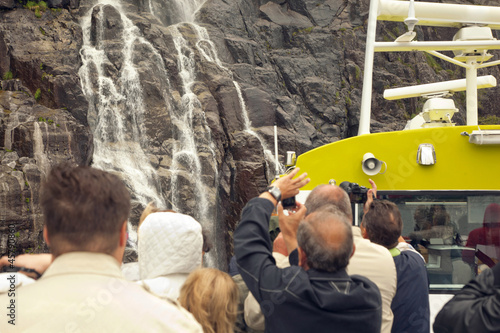 People on excursion near the waterfall photo