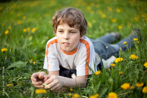 Little boyl lying in grass