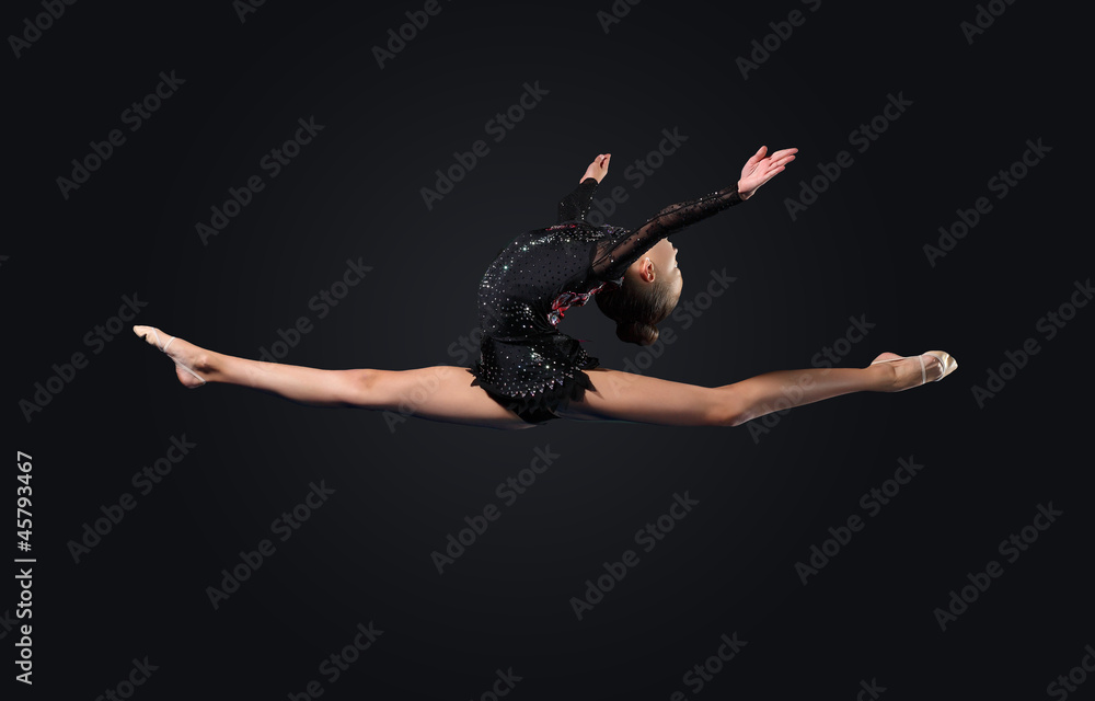 Naklejka premium Young woman in gymnast suit posing