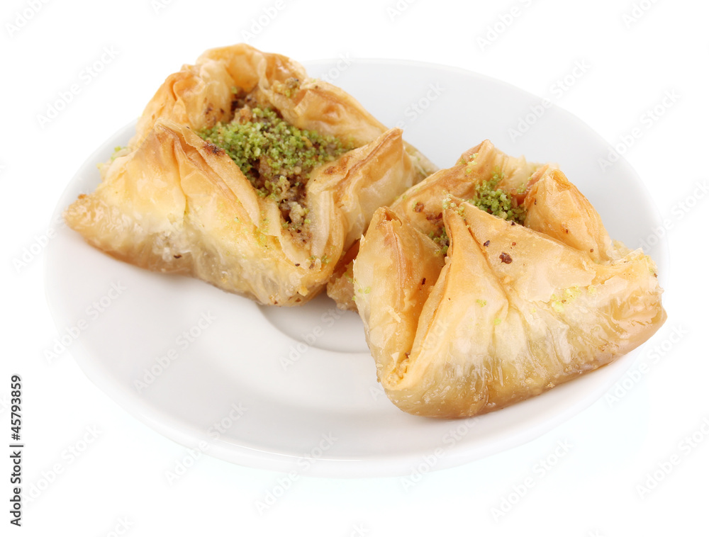 Sweet baklava on plate isolated on white Sweet baklava on plate isolated on white