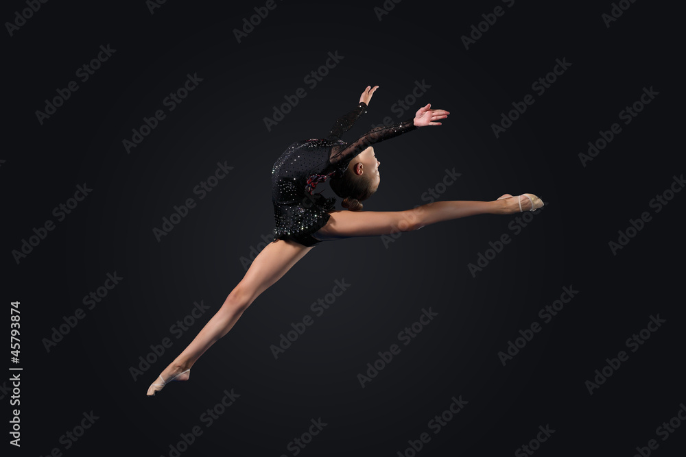 Naklejka premium Young woman in gymnast suit posing