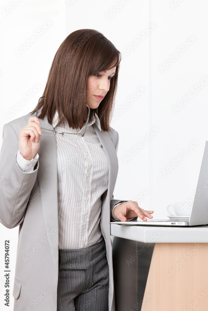 Working on the laptop businesswoman at the office Working on the laptop businesswoman at the office