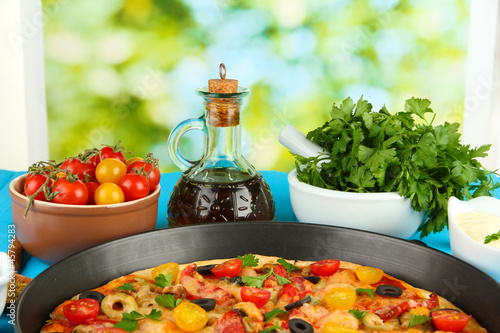 colorful composition of delicious pizza, vegetables and spices